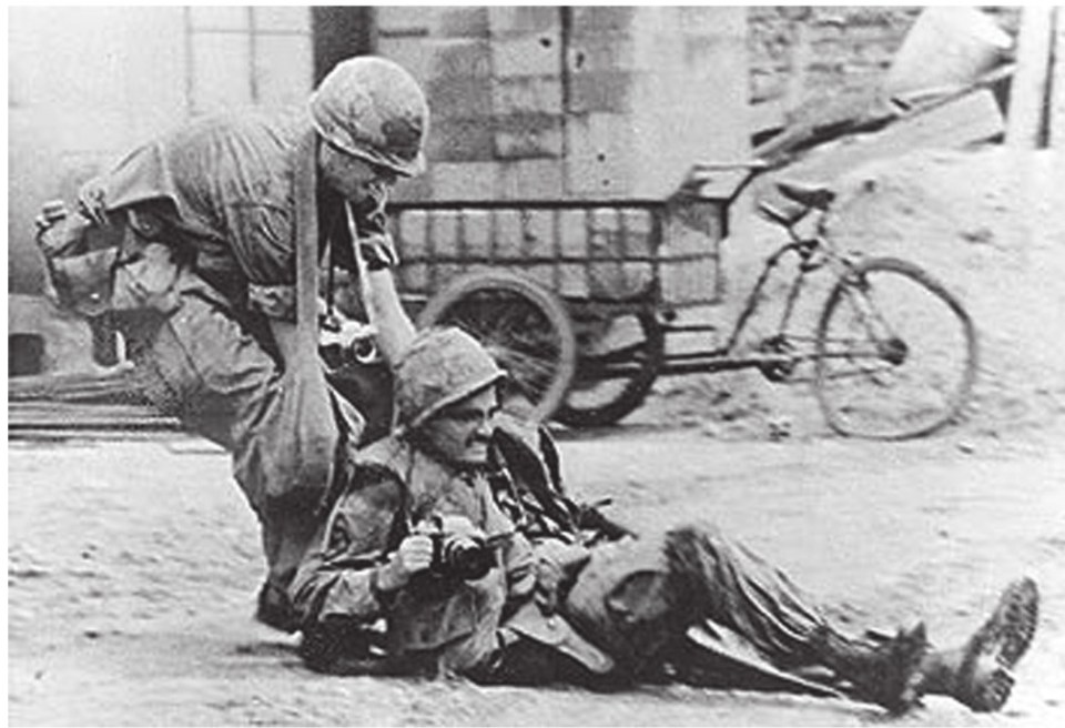  Sp4 Ransom Cyr, a 221st Signal Company photographer, pulls fellow 221st photographer Sp5 Charles K. Pollard to safety during the May 1968 attack. Cyr was later killed by enemy fire. He was awarded the Silver Star posthumously