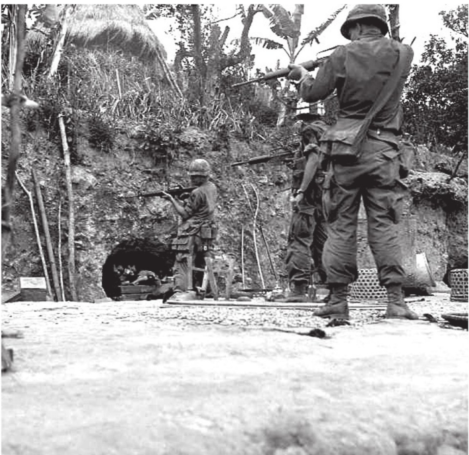  Just moments after this was shot, the three men in the photo were wounded by a grenade dropped by the Viet Cong fighter as he exited the cave