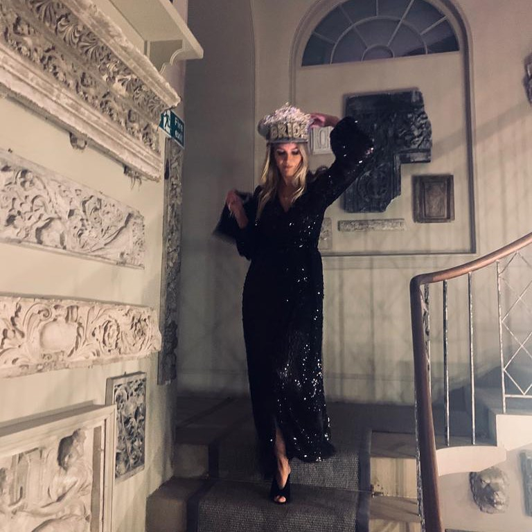  Lisa stuns in a glitzy black gown and embellished ha in a photo