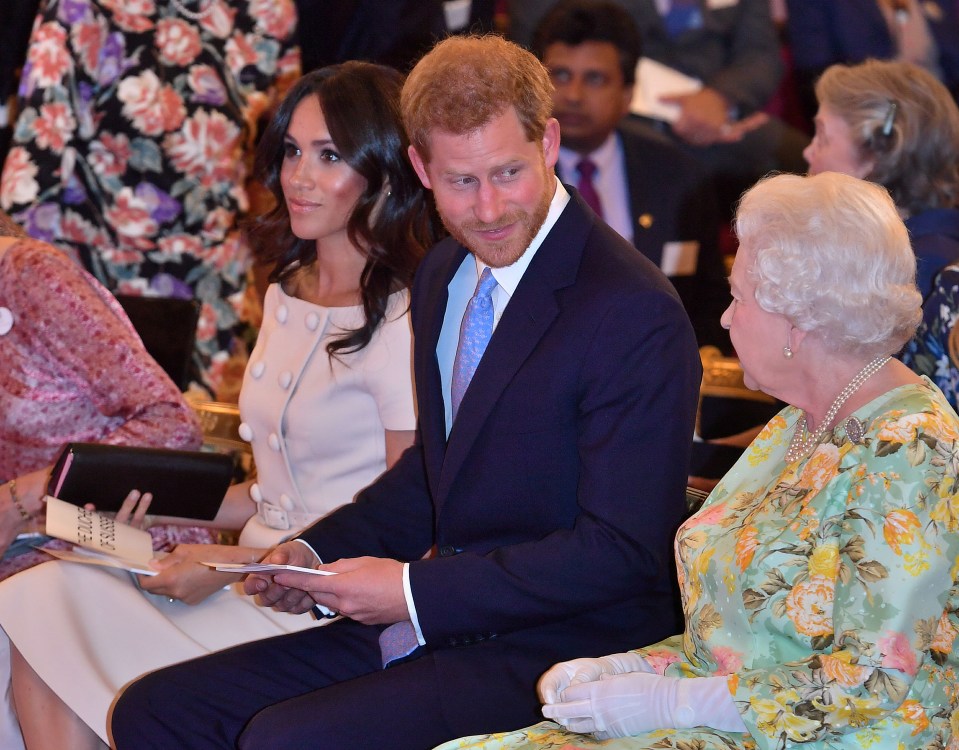 : Britain's Queen Elizabeth, Prince Harry and Meghan, the Duchess of Sussex pose for a picture with some of Queen's Young Leaders at a Buckingham Palace reception following the final Queen's Young Leaders Awards Ceremony, in London