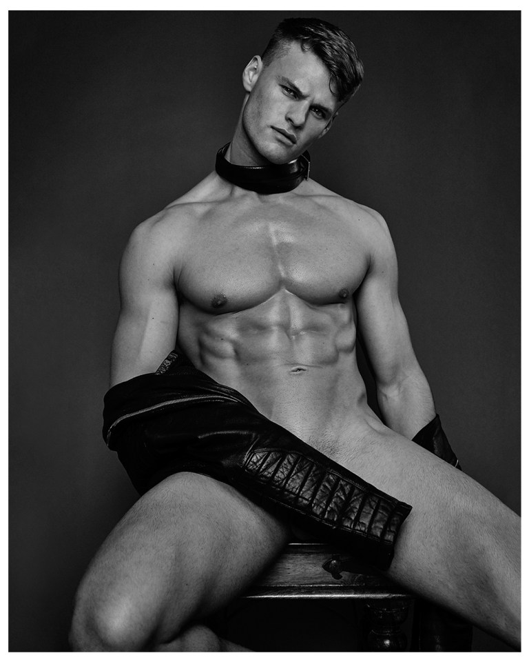  Josh wears a leather collar and shrugs off a leather jacket in an edgy shot