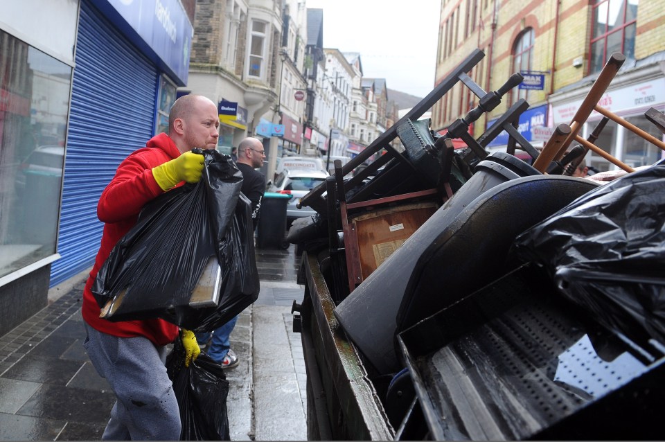 A man clears wreckage caused by the storm