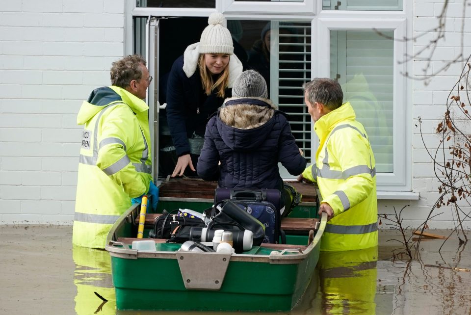  Emergency services rescue people from a flooded street in Hereford