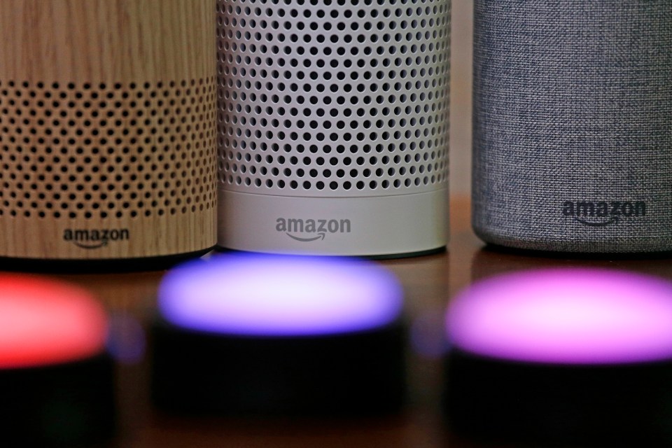 Three Amazon Echo smart speakers and illuminated Echo Buttons.