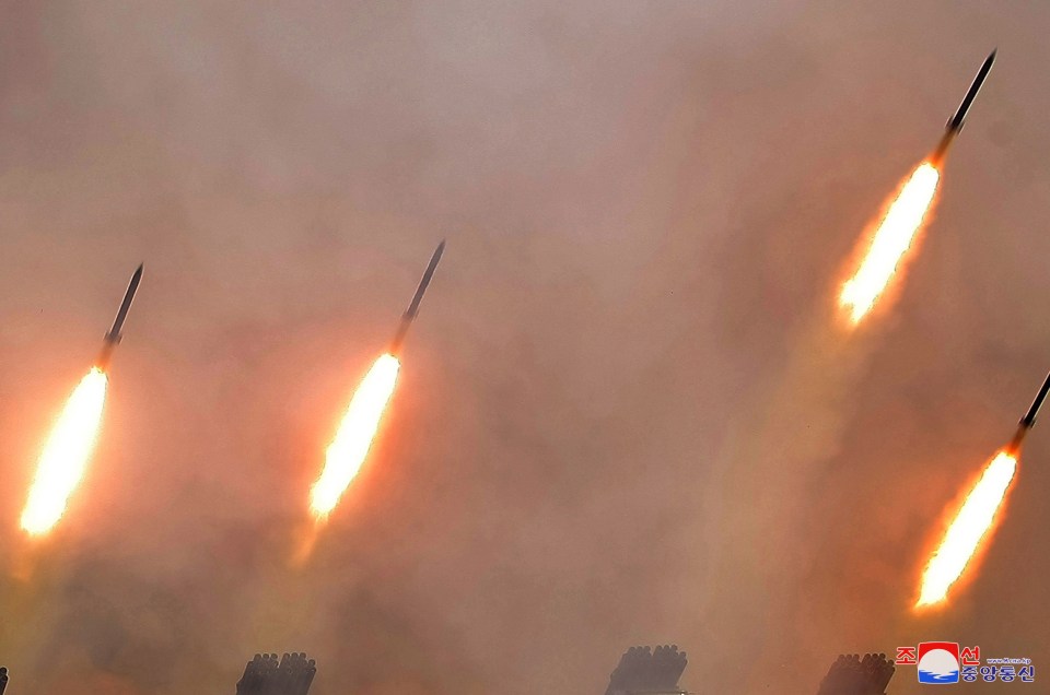 A photo released by the official North Korean Central News Agency shows multiple projectiles being launched during a long-range artillery drill