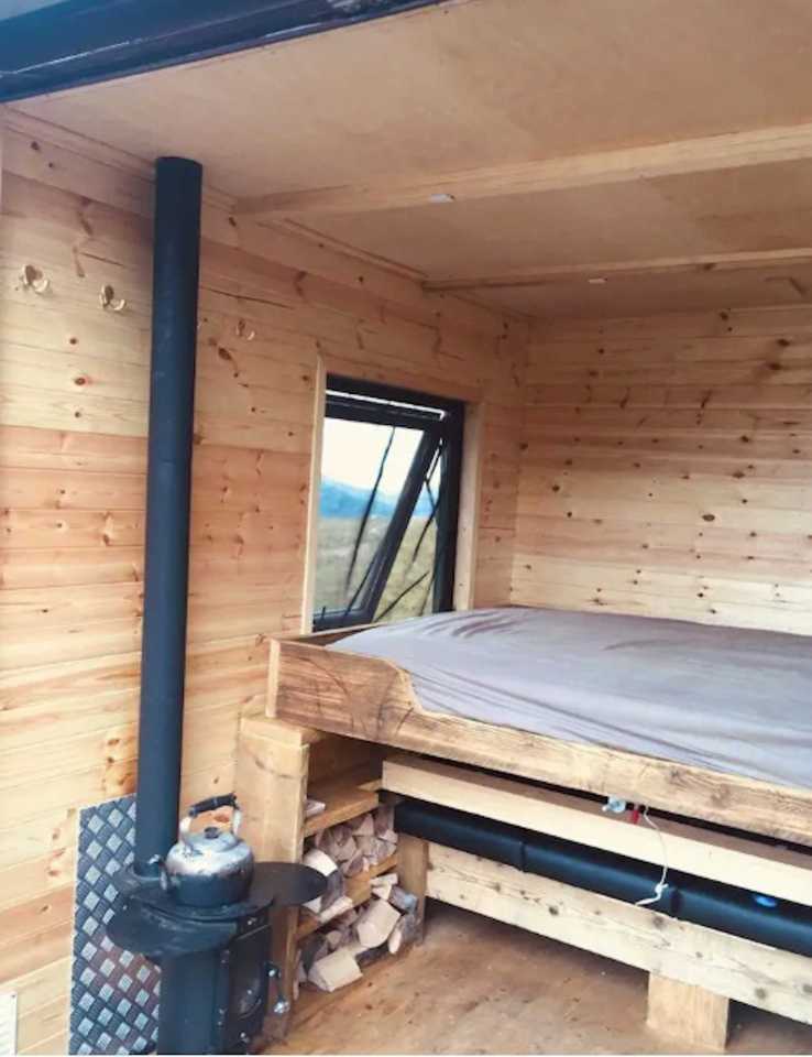  The box has a wooden couch which serves as a bed,  but renters must also bring their own sleeping bag