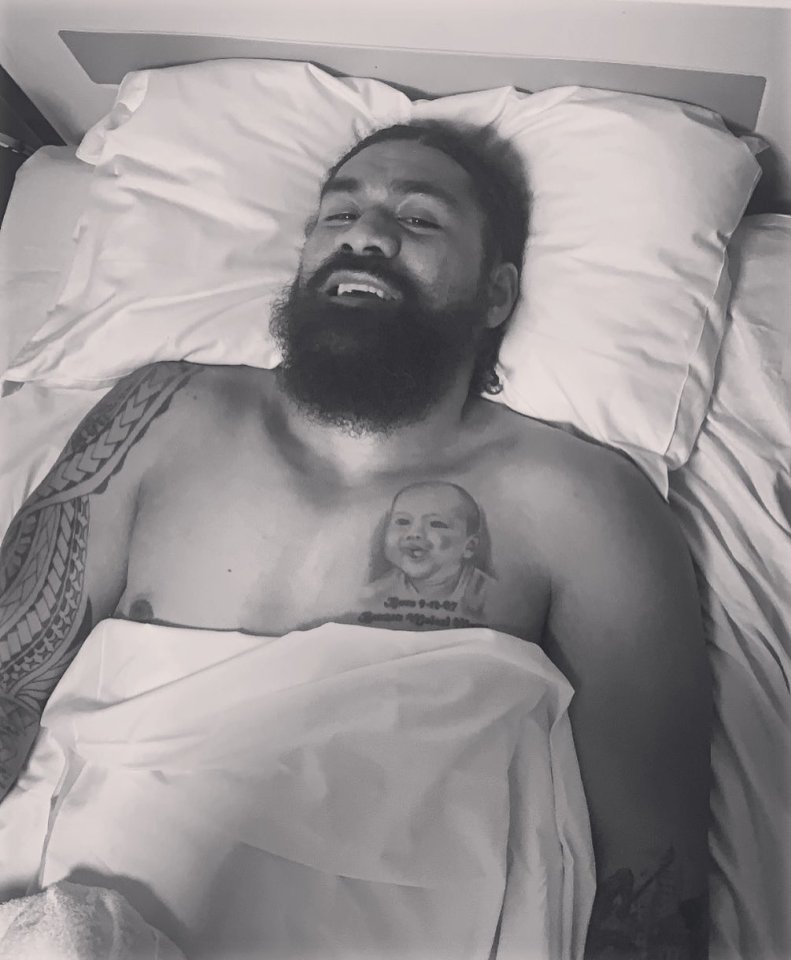 a man with a tattoo of a baby on his chest