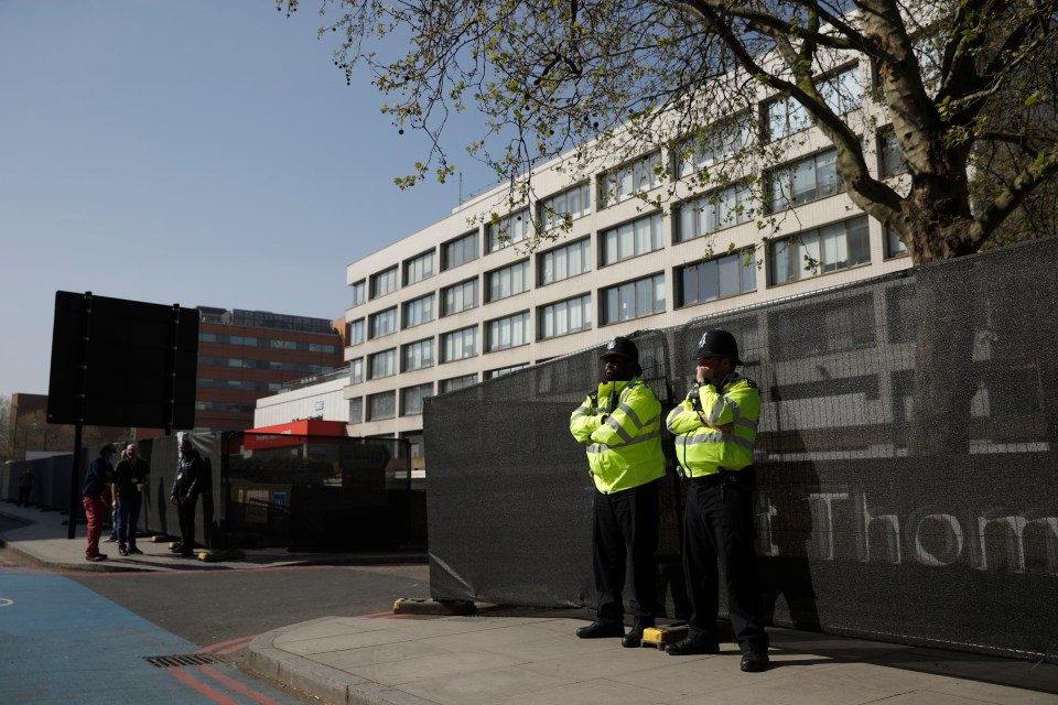 Police officers stand guard outside St Thomas' Hospital in London, where British Prime Minister Boris Johnson had been treated for coronavirus