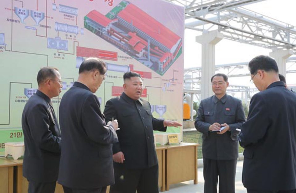  Kim Jong-un talks to his aides during his return to the public eye