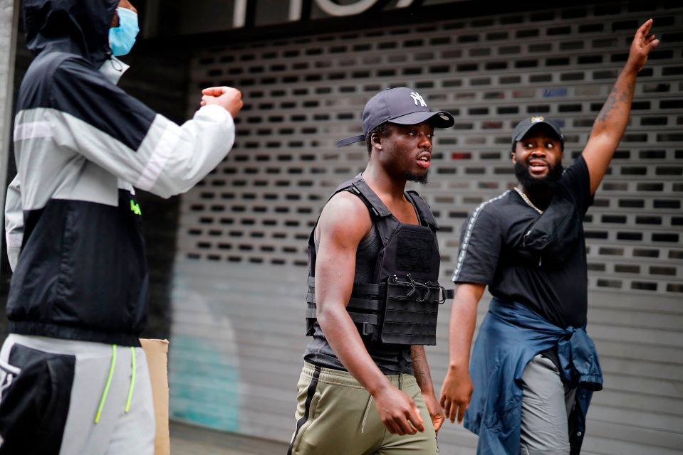  Men wear stabproof vests as they join protesters in London