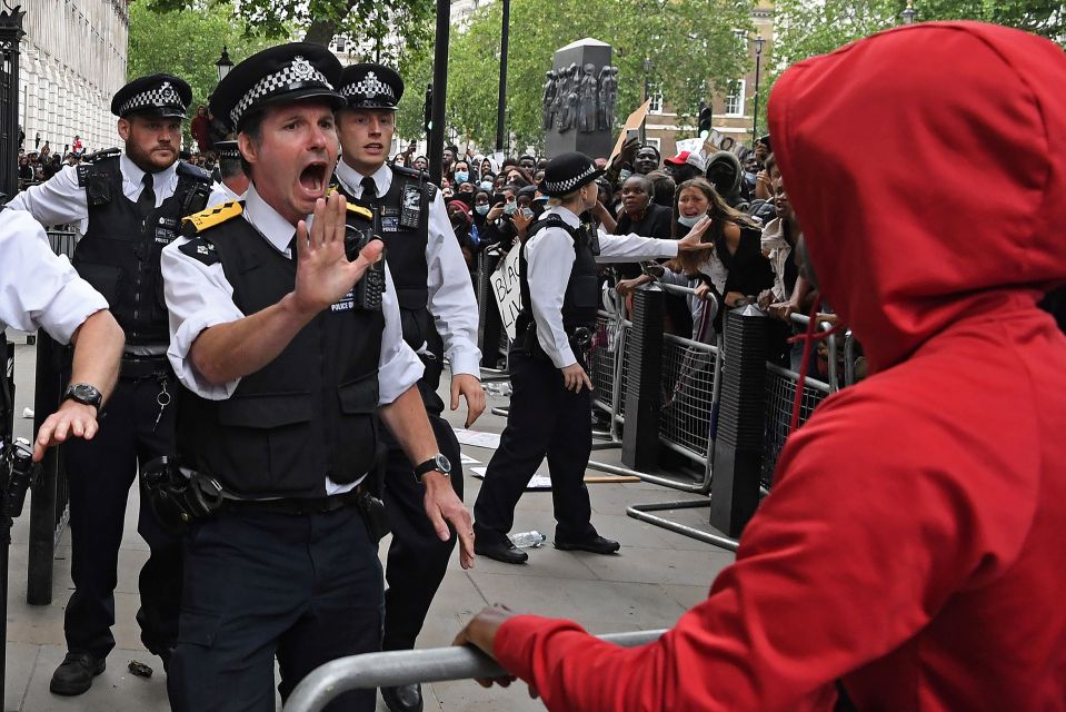  A cop tells a demonstrator to stand back at a Black Lives Matter protest near Downing Street