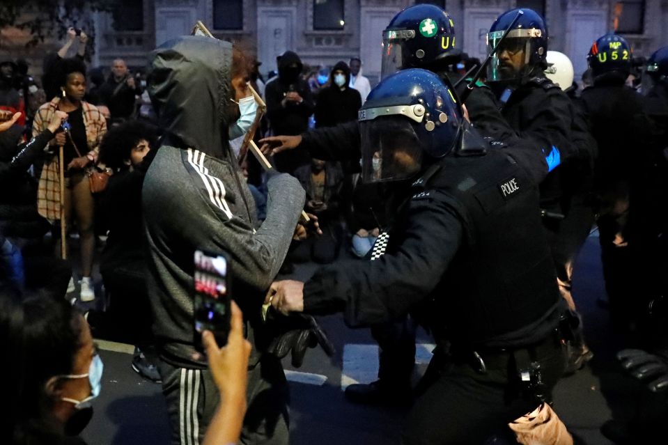  As darkness fell last night, there were clashes between protesters and police wearing riot gear