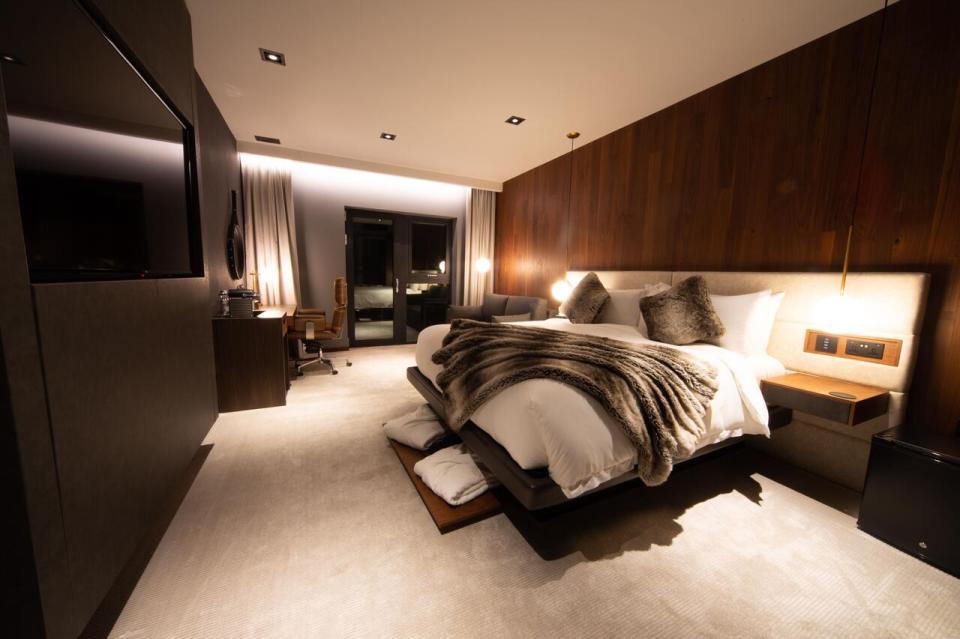 The bedroom decor is a mix of cream and coffee