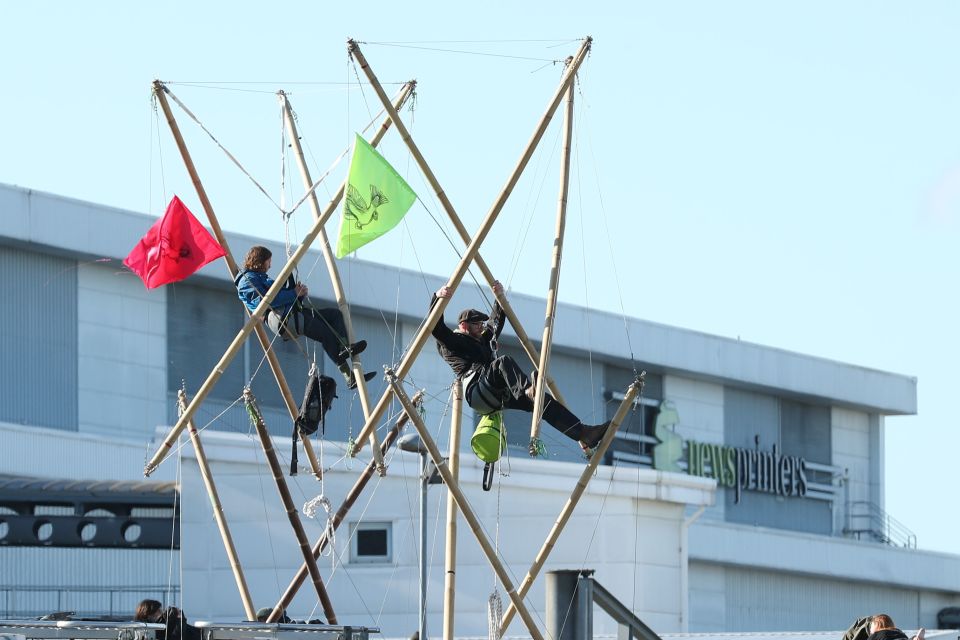 Protesters dangled in a contraption outside newsprinters