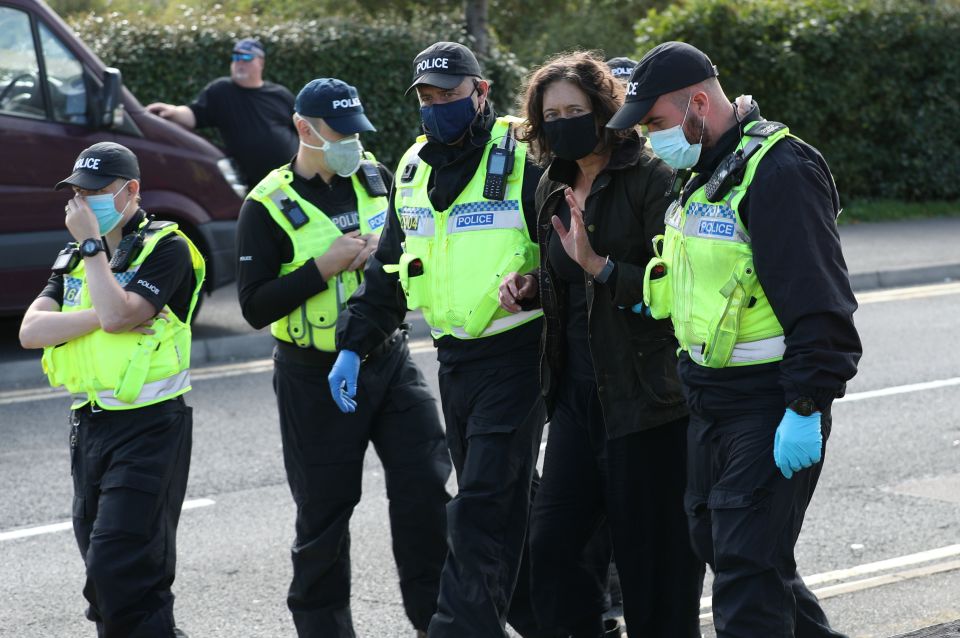 One protester is lead away by police outside the Newsprinters printing works at Broxbourne, Hertfordshire
