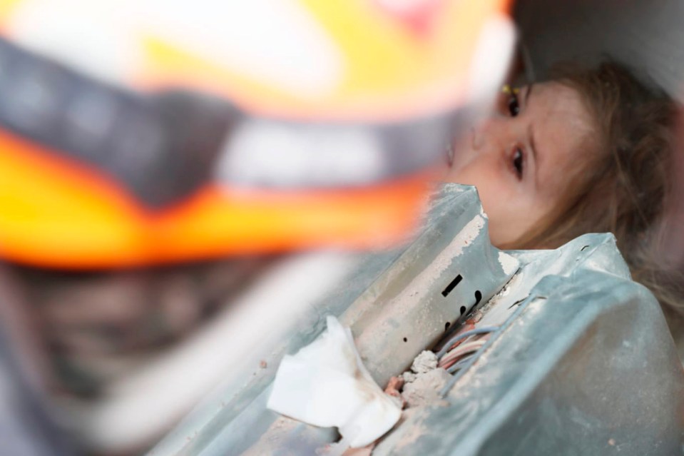 The four-year-old was found buried beneath layers of concrete and twisted metal