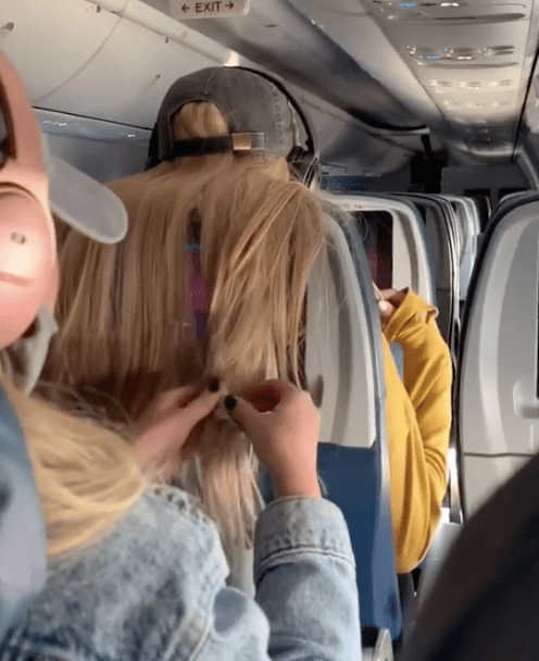 A TikTok clip shows a woman putting chewing gum, lollipops and coffee in another passenger's hair because it blocked her TV screen on a plane