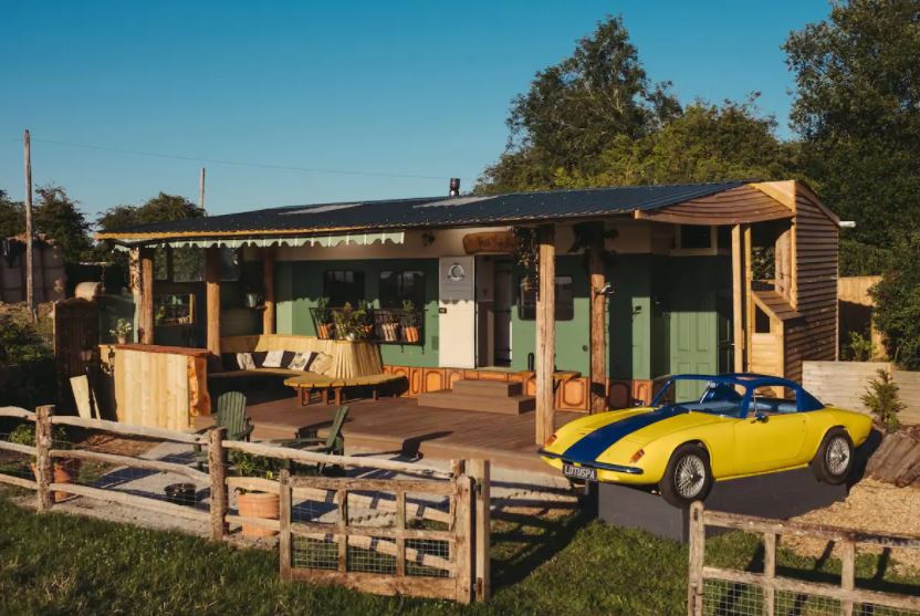 You can stay in a cosy cabin with a converted sports car hot tub
