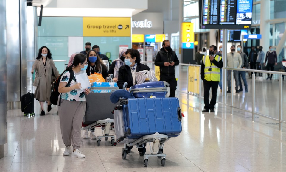 Travellers at Heathrow Airport in London today