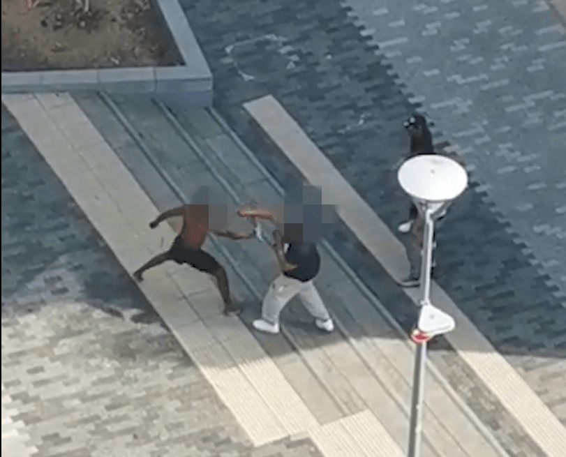 The shocking battle broke out in a residential area of North Greenwich while neighbours watched from their flats