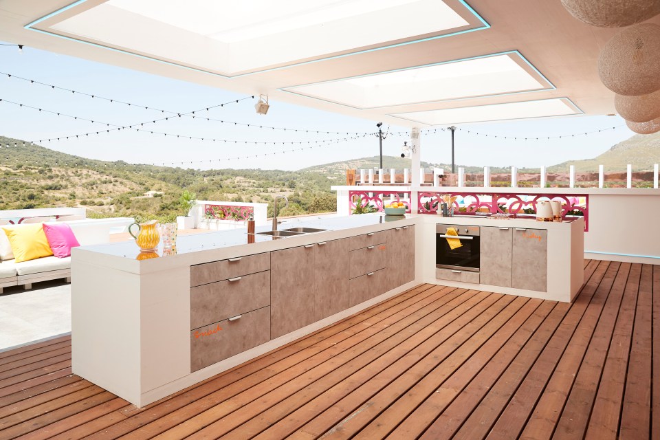 Outdoor kitchen in the Love Island villa overlooking a hillside.