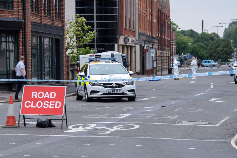 Forensic investigators gather evidence at the scene in Oxford town centre following an altercation in which three people were stabbed