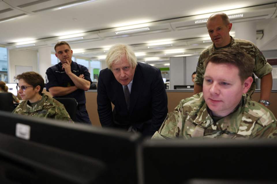 Prime Minister Boris Johnson observes the operations room for the Afghan Relocation and Assistance Policy as he visits Northwood
