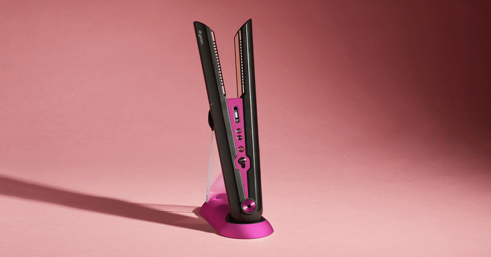 Dyson hair straightener on pink stand.