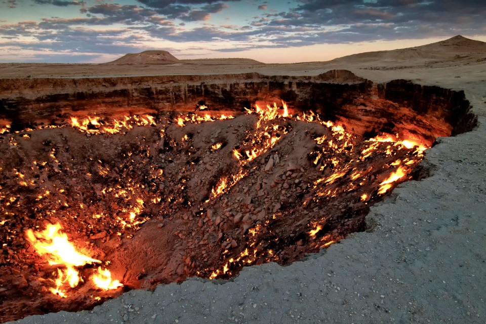 a large hole in the ground with fire coming out of it