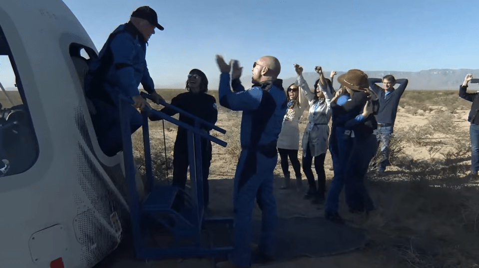 Shatner emerges from the capsule after landing in the Texas desert