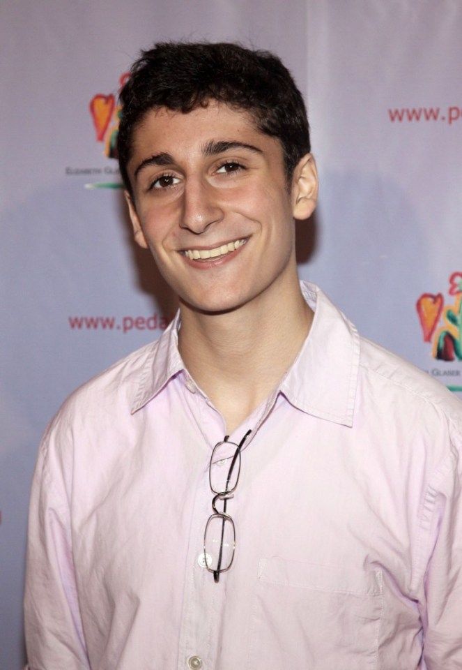 Headshot of a smiling young man.