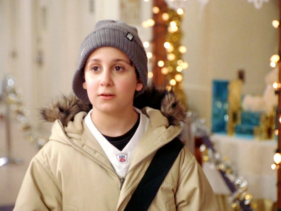 Boy in a knit cap and winter coat.