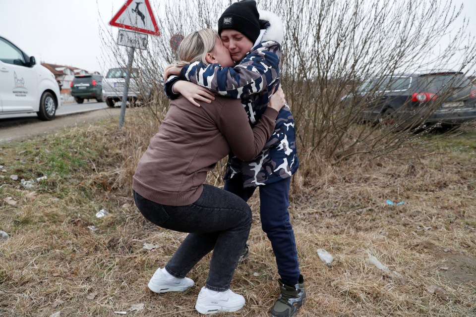 Anna Semyuk hugs her son after a stranger took her children across the Hungarian border and kept them safe while fleeing from Ukraine