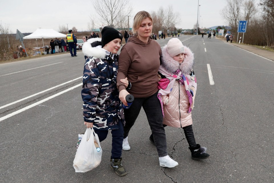 Anna walks with her children at the Beregsurany border crossing, Hungary