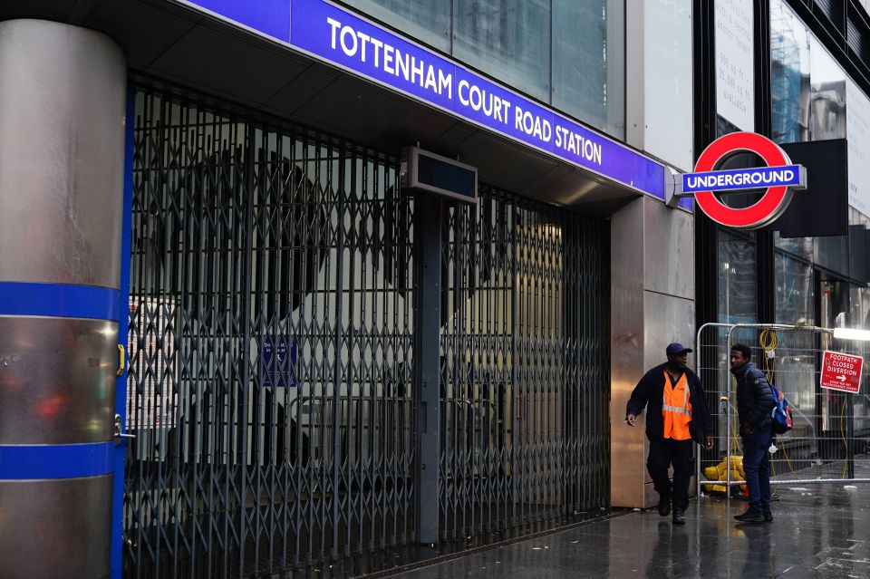 A man asks for travel advice outside Tottenham Court Road station