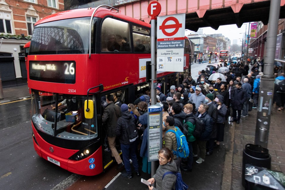 Commuters queue at a bus stop near Waterloo Station
