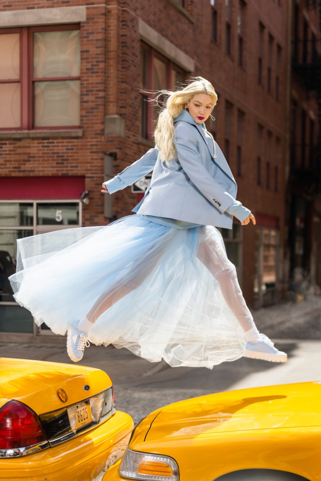 Gigi Hadid jumps from one taxi to another in New York while shooting an ad for make-up giant Maybelline