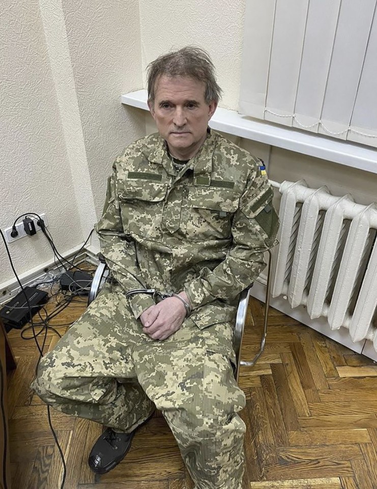 This undated and unlocated handout picture released on April 12, 2022 on the official Instagram account of Ukraineâs President Volodymyr Zelensky shows business tycoon Viktor Medvedchuk with his hands in cuffs and dressed in a Ukrainian army uniform.