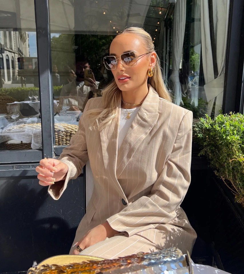 Millie stunned in this pinstripe suit as she enjoyed some outdoor dining