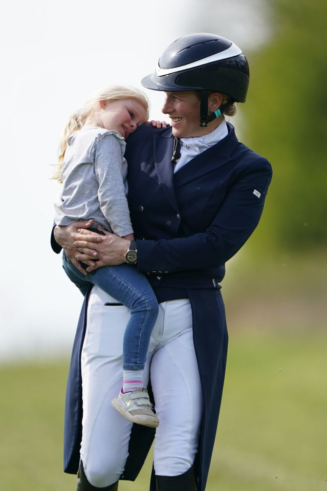 Lena being carried by her mother Zara Tindall, daughter of Princess Anne