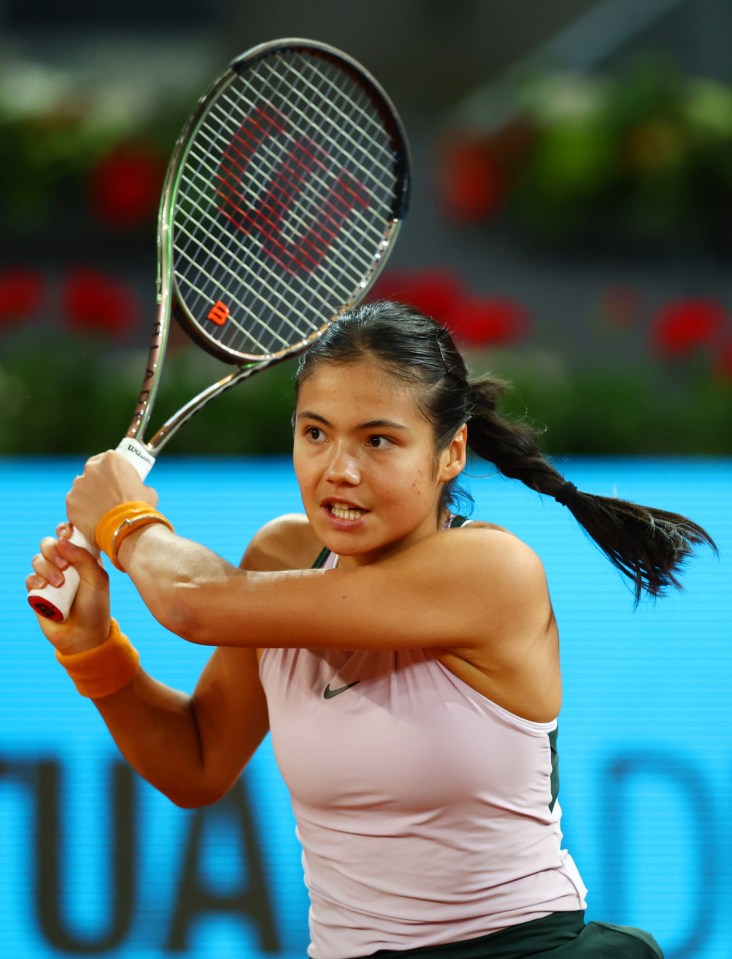 a woman is holding a wilson tennis racquet