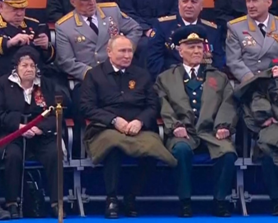 Vladimir Putin and a military officer at the Russian Victory Day parade.