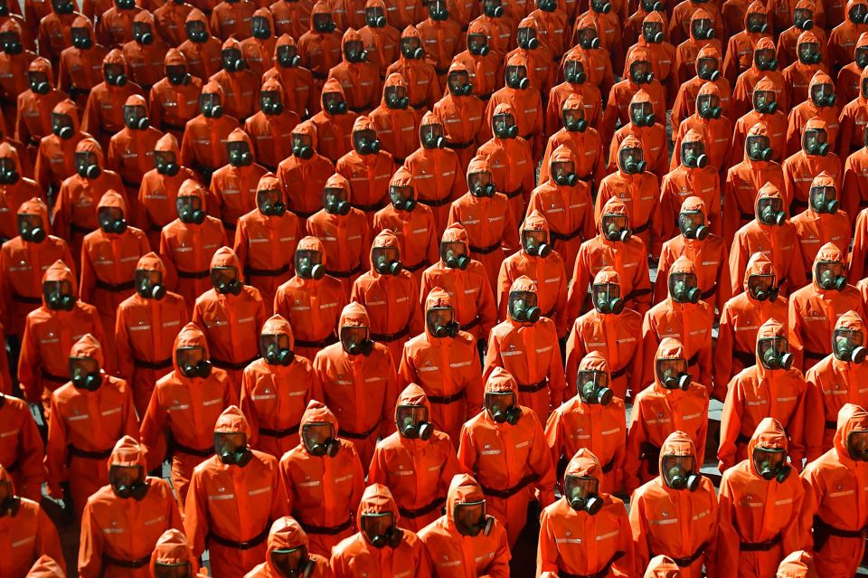 A gas-masked pandemic control unit during the parade celebrating the 73rd anniversary of the North Korean state