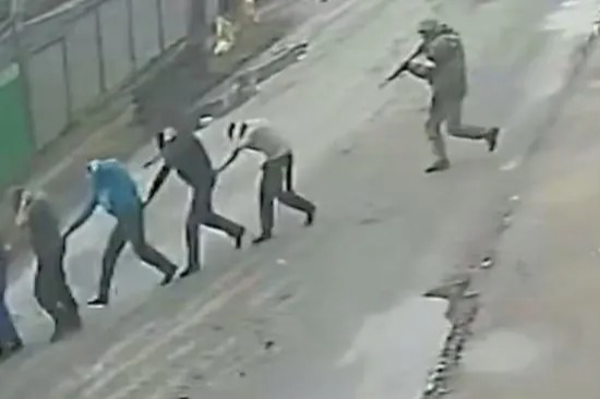 Russian soldiers marching Ukrainian civilians to their death