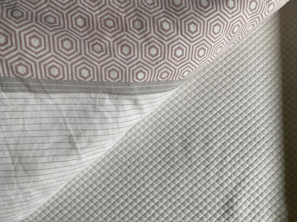 a close up of a bedspread with a pattern on it