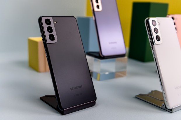 three samsung phones are on display on a table