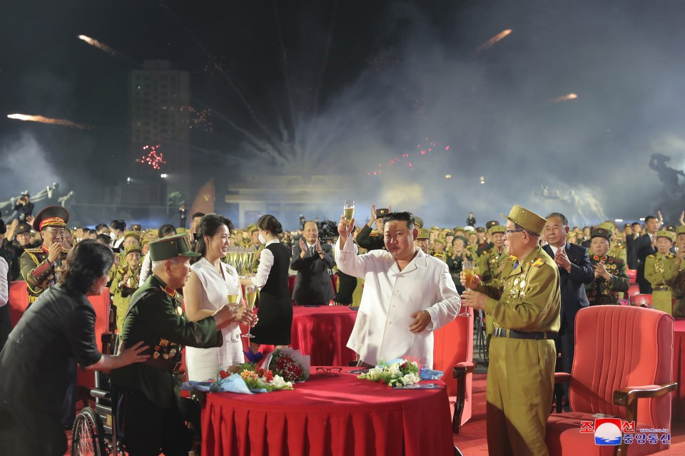 The tubby dictator was flanked by his soldiers