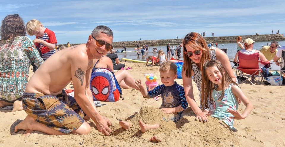 Chris and Rachel Mason with Zelda, five, and Stanley, two on the beach in North Tyneside