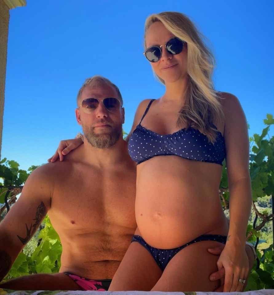 a man and a pregnant woman are posing for a picture