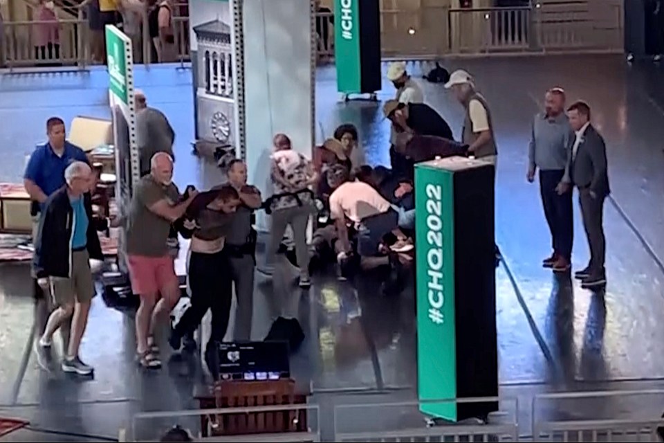 Still image showing Hadi Matar being escorted from a stage after an attack.